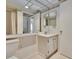 Neutral-toned bathroom with a wide mirror, vanity, and shower at 206 Andover N Pl # 96, Sun City Center, FL 33573