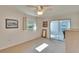 Bright bedroom with a ceiling fan, window and sliding glass door to a sunroom at 206 Andover N Pl # 96, Sun City Center, FL 33573