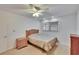 Bedroom with light carpet, ceiling fan and window at 206 Andover N Pl # 96, Sun City Center, FL 33573