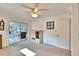 Bright bedroom with a ceiling fan and door to the sunroom with a built-in cabinet at 206 Andover N Pl # 96, Sun City Center, FL 33573
