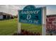 A neighborhood sign with lush green landscaping and nearby residential buildings at 206 Andover N Pl # 96, Sun City Center, FL 33573