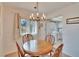 Cozy dining area with chandelier lighting and a view to the laundry space at 206 Andover N Pl # 96, Sun City Center, FL 33573