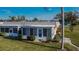 Lovely home exterior featuring a well-manicured lawn, lush landscaping and a cozy enclosed porch at 206 Andover N Pl # 96, Sun City Center, FL 33573
