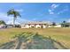 A well-kept single-story home featuring a mature palm tree and manicured lawn at 206 Andover N Pl # 96, Sun City Center, FL 33573