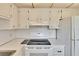 Bright kitchen featuring white appliances and cabinets with ample counter space at 206 Andover N Pl # 96, Sun City Center, FL 33573