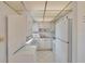 Cozy kitchen featuring white appliances, cabinets, and diamond tile flooring at 206 Andover N Pl # 96, Sun City Center, FL 33573