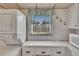 Functional laundry area with a window view, washer, dryer, and cabinet space at 206 Andover N Pl # 96, Sun City Center, FL 33573