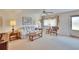 Inviting living room with neutral carpet, a ceiling fan, and comfortable furniture at 206 Andover N Pl # 96, Sun City Center, FL 33573