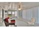 Enclosed Florida room featuring bright natural light and multiple exit doors at 206 Andover N Pl # 96, Sun City Center, FL 33573