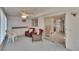 Enclosed lanai with wicker furniture and view of the bedroom through sliding glass door at 206 Andover N Pl # 96, Sun City Center, FL 33573