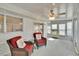 Enclosed patio with wicker furniture and views of the yard at 206 Andover N Pl # 96, Sun City Center, FL 33573