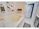 This bathroom features a soaking tub and an open doorway to a water closet at 221 Sela Cove Cir, Apollo Beach, FL 33572