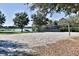 A sand volleyball court with a scenic view of the lake and surrounding greenery at 221 Sela Cove Cir, Apollo Beach, FL 33572