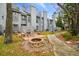 Townhome backyard featuring a fire pit, patio furniture, and green space at 2515 S Ysabella Ave, Tampa, FL 33629