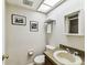 Cozy bathroom featuring a classic toilet, sink and framed art at 2515 S Ysabella Ave, Tampa, FL 33629