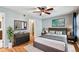 Comfortable bedroom featuring hardwood floors, ceiling fan, and decor at 2515 S Ysabella Ave, Tampa, FL 33629