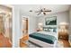 Comfortable bedroom showcasing a ceiling fan, wood floors, and an ensuite bathroom at 2515 S Ysabella Ave, Tampa, FL 33629