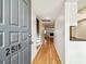 Inviting entryway featuring hardwood floors and a view into the living room with a cozy fireplace at 2515 S Ysabella Ave, Tampa, FL 33629