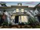 Charming townhome featuring a covered entry, black door, light gray paint, and well-maintained landscaping at 2515 S Ysabella Ave, Tampa, FL 33629