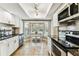 Contemporary kitchen with bay window, stainless appliances, and stylish lighting at 2515 S Ysabella Ave, Tampa, FL 33629