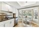 Bright kitchen with granite counters, white cabinetry, stainless appliances, and large windows at 2515 S Ysabella Ave, Tampa, FL 33629