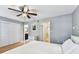 Main bedroom featuring hardwood floors, ceiling fan, double closet, and ensuite bathroom at 2515 S Ysabella Ave, Tampa, FL 33629