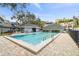 Community pool surrounded by pavers with chairs and tables for residents on a beautiful clear day at 2515 S Ysabella Ave, Tampa, FL 33629