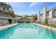 A refreshing community pool with sun loungers, tables, and umbrellas at 2515 S Ysabella Ave, Tampa, FL 33629