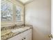 Tasteful bathroom vanity featuring granite counters, mosaic tile backsplash, and modern fixtures at 2515 S Ysabella Ave, Tampa, FL 33629