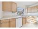 Kitchen featuring light wood cabinets, a sink, and ample counter space under the window at 2801 N 75Th St, Tampa, FL 33619