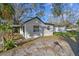 Exterior shot revealing the spacious side yard and home, surrounded by lush greenery at 2801 N 75Th St, Tampa, FL 33619