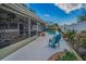 Inviting backyard featuring a screened-in lanai, a sparkling pool, and lush landscaping at 3111 Teal Ter, Safety Harbor, FL 34695