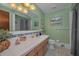 Charming bathroom featuring green walls, a white sink with tiled accents, and a shower with a curtain at 3111 Teal Ter, Safety Harbor, FL 34695