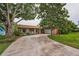 Charming brick home with mature trees and a long driveway at 3111 Teal Ter, Safety Harbor, FL 34695