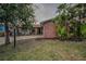 Charming single-story brick home featuring a well-manicured lawn and tropical landscaping at 3111 Teal Ter, Safety Harbor, FL 34695