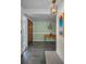 Entryway with slate tile flooring, wood door with glass inserts, pendant light, and decorative wall art at 3111 Teal Ter, Safety Harbor, FL 34695
