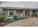 Inviting front porch with brick columns and a decorative sun art piece at 3111 Teal Ter, Safety Harbor, FL 34695