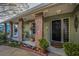 Charming front porch features brick pillars, decorative plants, and a welcoming entryway with a classic black door at 3111 Teal Ter, Safety Harbor, FL 34695