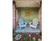 Cozy porch with decorative sun art and seating at 3111 Teal Ter, Safety Harbor, FL 34695