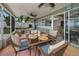 Relaxing screened-in lanai with dining set, ceiling fans, and view of the backyard at 3111 Teal Ter, Safety Harbor, FL 34695