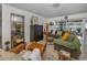Cozy living room with comfortable seating, a decorative mirror, and view to the patio at 3111 Teal Ter, Safety Harbor, FL 34695