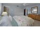 A large main bedroom with a ceiling fan, hardwood floors, and an attached bathroom at 3111 Teal Ter, Safety Harbor, FL 34695