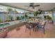 Inviting screened patio with ceiling fans, dining furniture, and relaxing view of the pool at 3111 Teal Ter, Safety Harbor, FL 34695