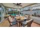 Enclosed patio includes outdoor dining set and seating near the refreshing pool at 3111 Teal Ter, Safety Harbor, FL 34695