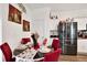 Dining room with table set and stainless steel refrigerator in kitchen at 35530 Shade Fern Ln, Zephyrhills, FL 33541