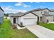 Inviting single-story home featuring a concrete driveway and manicured front yard at 35530 Shade Fern Ln, Zephyrhills, FL 33541