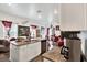 Kitchen island with sink and view into dining room area at 35530 Shade Fern Ln, Zephyrhills, FL 33541