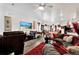 Bright living room featuring a large TV, comfortable seating, and stylish decor at 35530 Shade Fern Ln, Zephyrhills, FL 33541