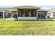 Screened back porch and lush green backyard on a sunny day at 38189 Countryside Pl, Dade City, FL 33525