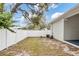 Fenced backyard with an air conditioning unit and some trees at 4104 E Comanche Ave, Tampa, FL 33610
